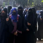 Muslim female students wearing hijabs are denied entry to classrooms in Udupi, reflecting rights violations in India's Karnataka [Image Credits: AP]
