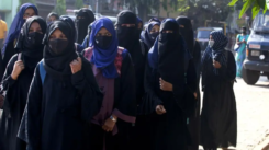 Muslim female students wearing hijabs are denied entry to classrooms in Udupi, reflecting rights violations in India's Karnataka [Image Credits: AP]