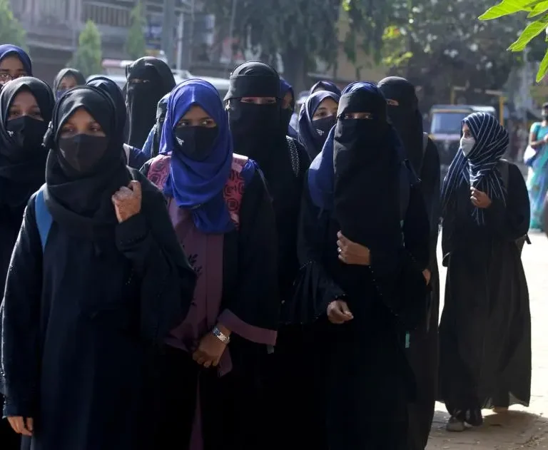 Muslim female students wearing hijabs are denied entry to classrooms in Udupi, reflecting rights violations in India's Karnataka [Image Credits: AP]