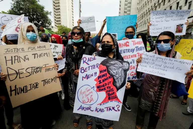 Women are holding banners on women Day in Pakistan.