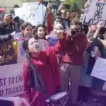 Women are standing with placards at Aurat March in support of Feminism.
