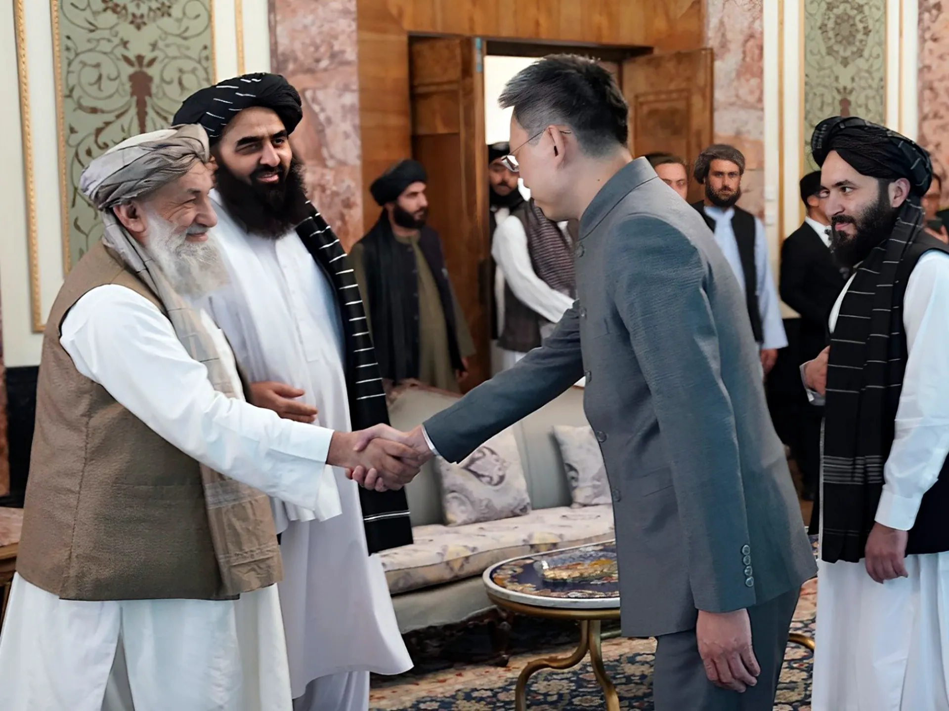 Ambassador Zhao Sheng of China shakes hands with Taliban Prime Minister Mohammad Hasan Akhund during a recognition ceremony in Kabul, Afghanistan. Date: September 13, 2023. Image courtesy: Taliban Prime Minister Media Office via AP.