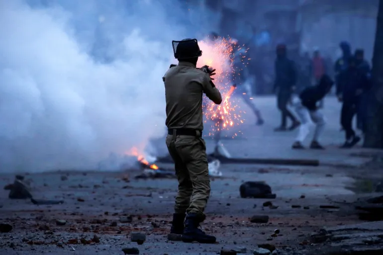 An Indian police officer fires a tear gas shell during a protest in Srinagar last year [File: Danish Ismail/Reuters]