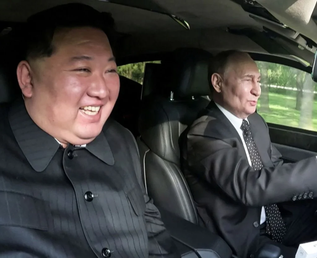 Vladimir Putin and Kim Jong Un ride in an Aurus car in Pyongyang, North Korea. [Image via Reuters]