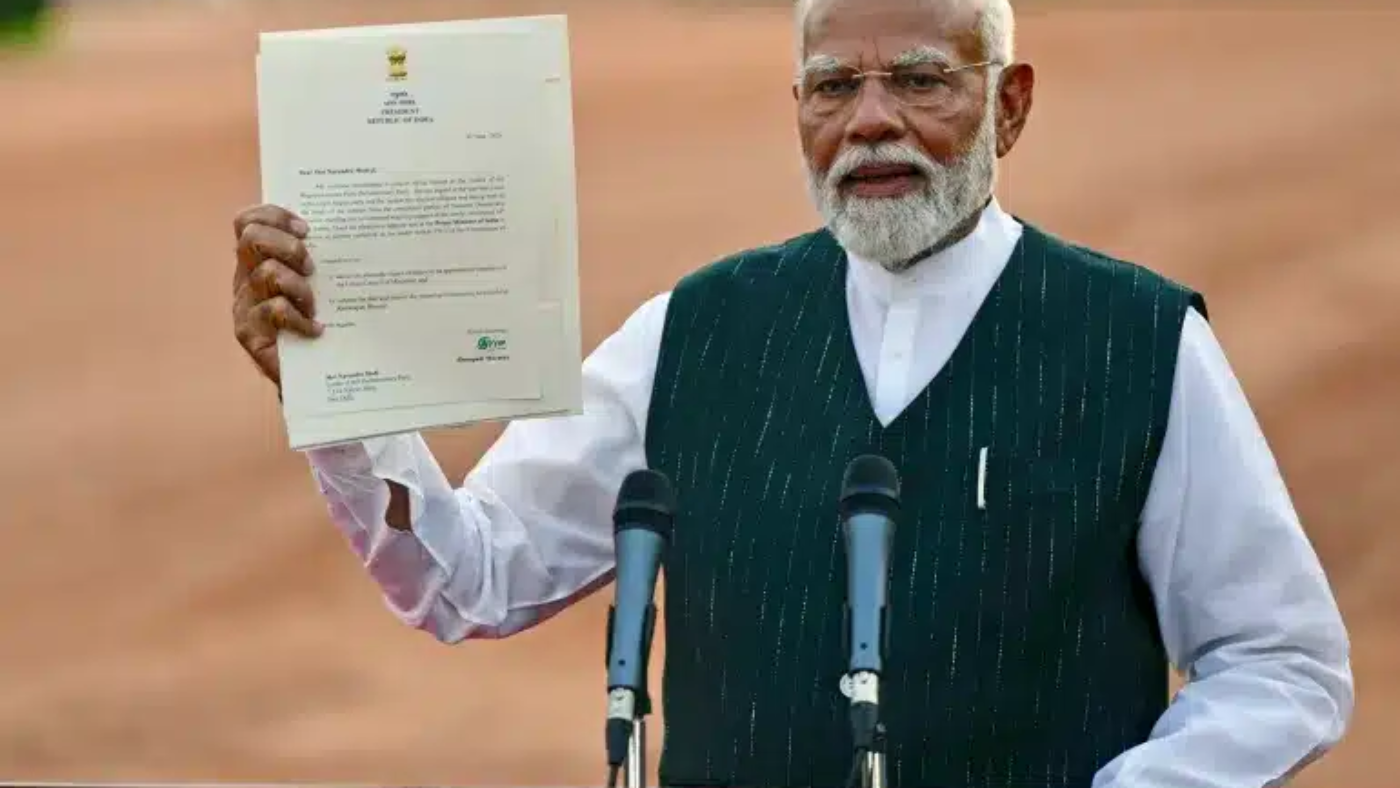 On June 7, 2024, in New Delhi, Indian PM Narendra Modi showcases a letter from President Droupadi Murmu, inviting him to form the next government. This comes amid the fall of Bharatiya Janata Party (BJP) in the 2024 Lok Sabha elections, indicating a decline in Modi's popularity.