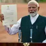 On June 7, 2024, in New Delhi, Indian PM Narendra Modi showcases a letter from President Droupadi Murmu, inviting him to form the next government. This comes amid the fall of Bharatiya Janata Party (BJP) in the 2024 Lok Sabha elections, indicating a decline in Modi's popularity.