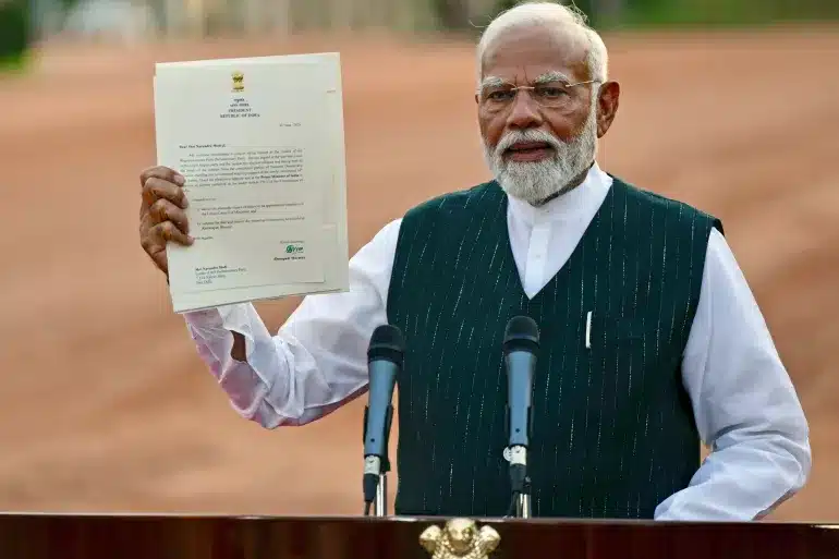 On June 7, 2024, in New Delhi, Indian PM Narendra Modi showcases a letter from President Droupadi Murmu, inviting him to form the next government. This comes amid the fall of Bharatiya Janata Party (BJP) in the 2024 Lok Sabha elections, indicating a decline in Modi's popularity.