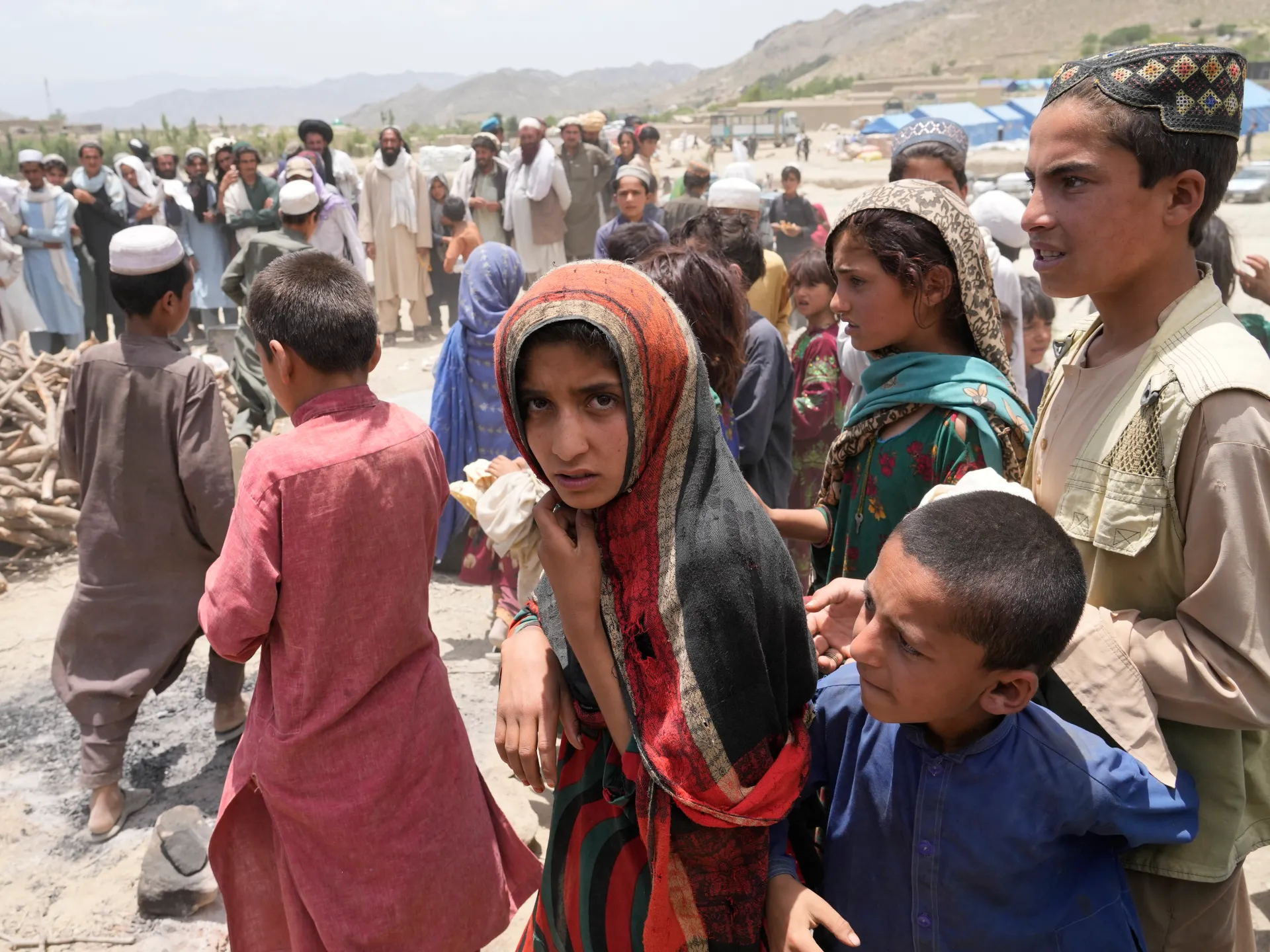 Afghan earthquake survivors receive aid at a camp in Gayan district, Paktika province, Afghanistan, on June 26, 2022. [Image via AP]