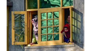 At its core, what defines Kashmir's identity? Kashmiri women look through a window in Pulwama, South Kashmir amid crisis. [Image via PTI]