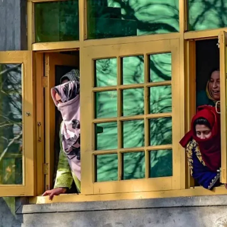 At its core, what defines Kashmir's identity? Kashmiri women look through a window in Pulwama, South Kashmir amid crisis. [Image via PTI]
