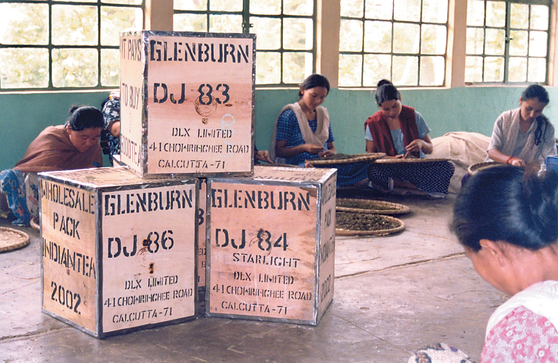 Stacked tea chests in a storage area [Image via Travel Journalist, Subhasish Chakraborty]