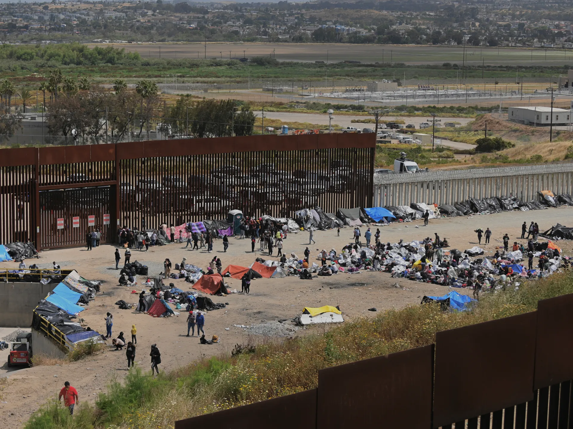 2024 US Presidential Debate and Immigration: Migrants at Tijuana-San Diego border hope for easier US immigration after Title-42 expiration, seen May 11, 2023. [Image via Al Jazeera]