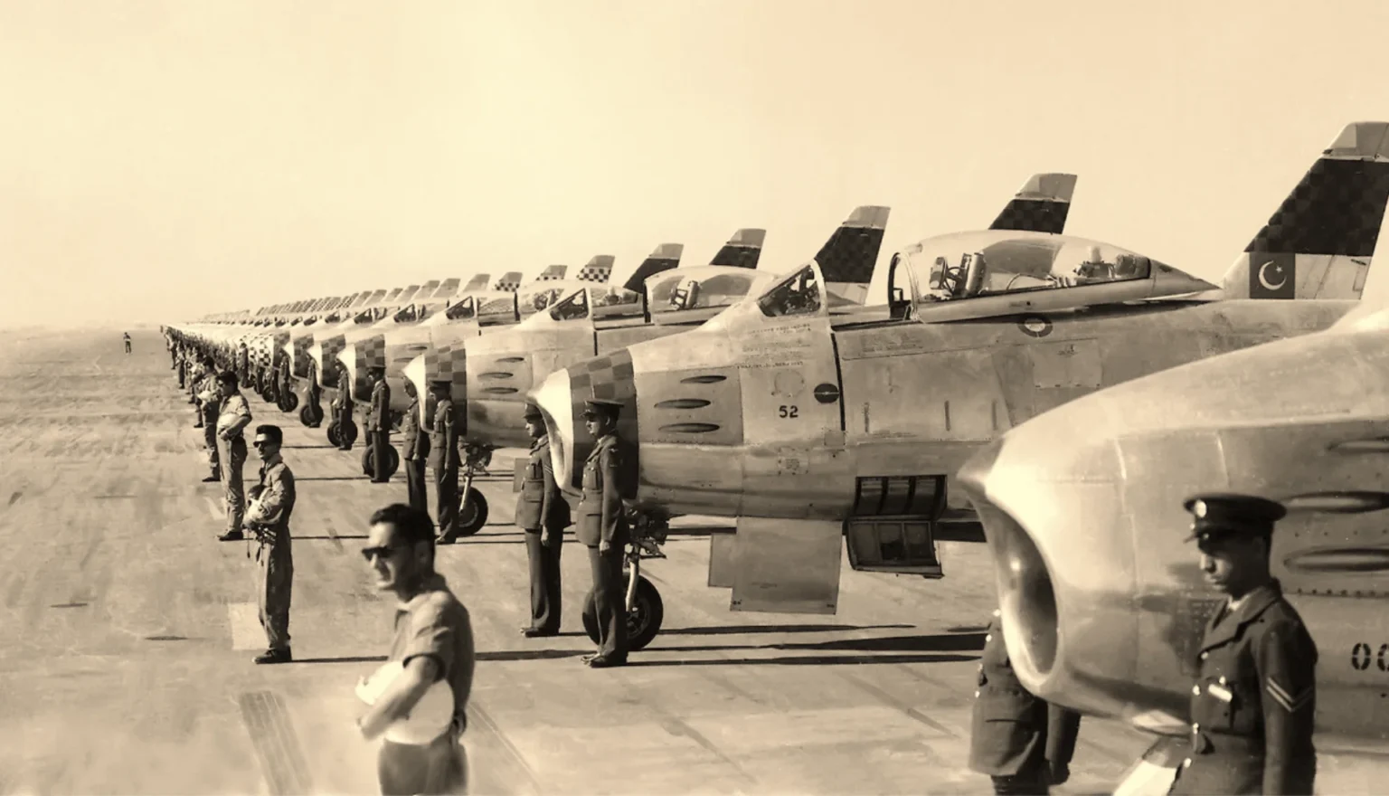 Wing Commander Zafar Masud led the Sixteen Sabres Loop in Mauripur on February 2, 1958, with pilots lined up for the display. [Image via PAF]