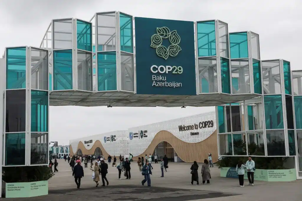 COP29 in Baku faces delays and controversy over climate issues. With key absences and trade disputes, will the summit deliver on urgent climate action? [Image via Reuters]