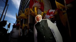 Protesters display a cutout of Indian Prime Minister Narendra Modi during a Sikh rally outside the Indian consulate in Toronto amid the India-Canada row. [Image via Cole Burston/AFP].