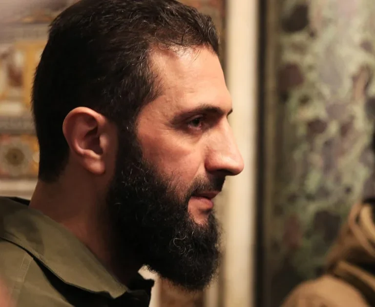 Jolani's vision for Syria focuses on reform, inclusivity, and distancing from the Taliban model, as the U.S. cautiously engages with HTS leadership. [Image via NBC News]