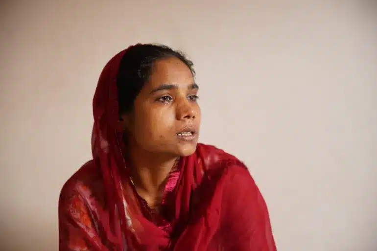 Salma Bano struggles to hold back her tears. Bano’s house in Akbar Nagar, Uttar Pradesh, was demolished in June 2024 as part of a riverfront development project, disrupting her children’s schooling [Aljazeera]