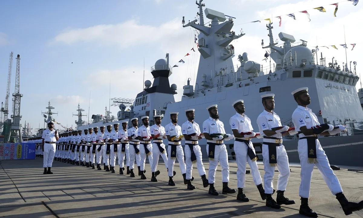 Pakistan Naval personnel carry national flags of participating countries during the opening ceremony of Pakistan Navy's Multinational Exercise AMAN-23 (PEACE), in Karachi, Pakistan, on February 10, 2023. [Photo: VCG]