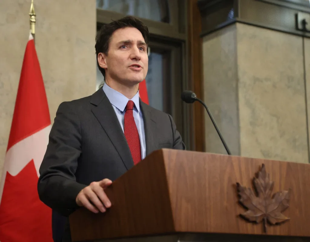 Trudeau calls Trump's tariffs "very dumb," vows retaliation as U.S.-Canada trade war escalates, hitting key industries. [Image via PBS News]