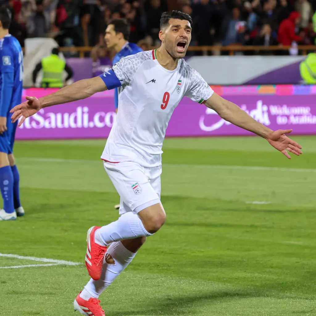Iran qualify for the 2026 World Cup, but U.S. visa bans may pose challenges for fans and players. Uzbekistan nears first-ever spot. [Image via AFP]