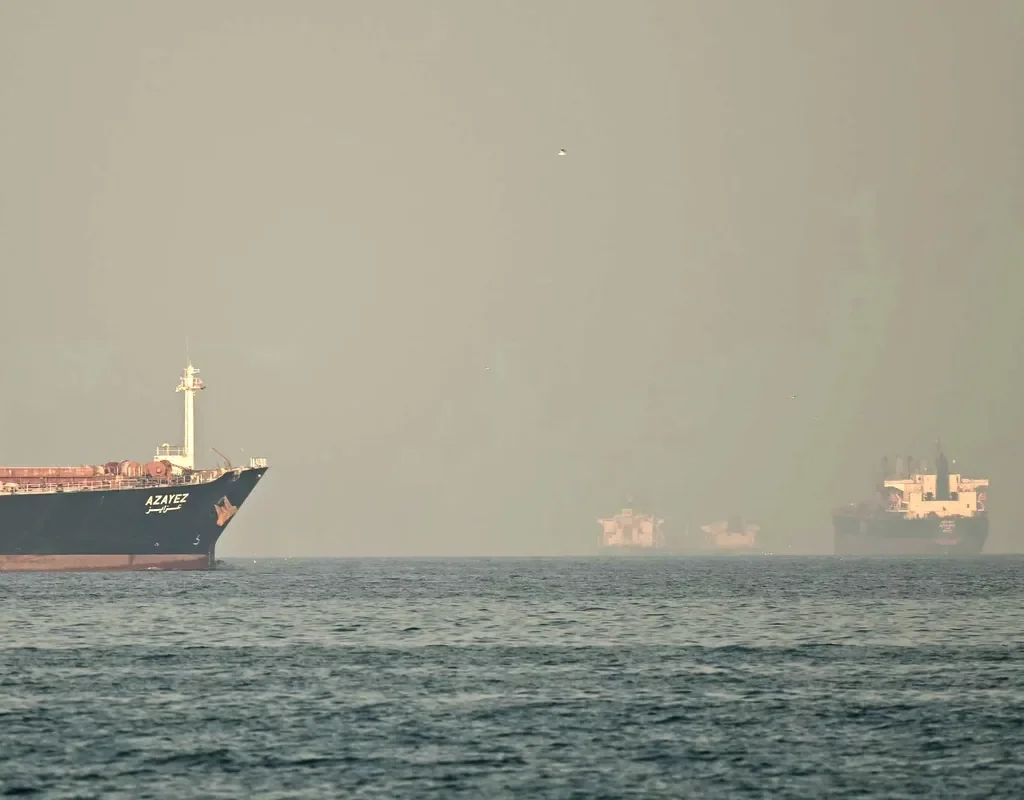 Cargo ships and tankers in the Strait of Hormuz in the northern Emirate. Photographer: Giuseppe Cacace/AFP/Getty Images
