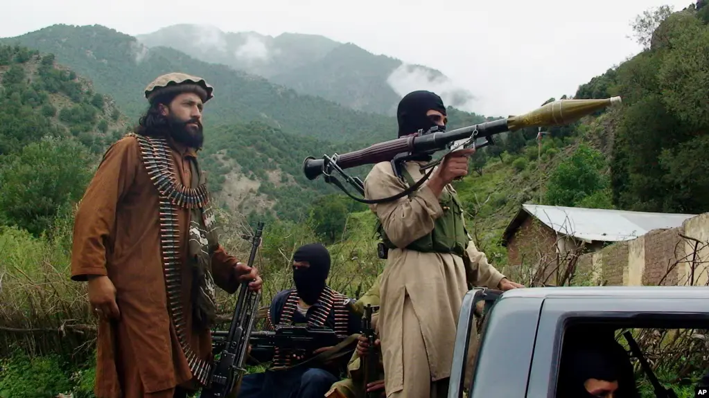 Pakistani Taliban patrol in then their stronghold of Shawal in Pakistani tribal region of South Waziristan, Aug. 5, 2012.