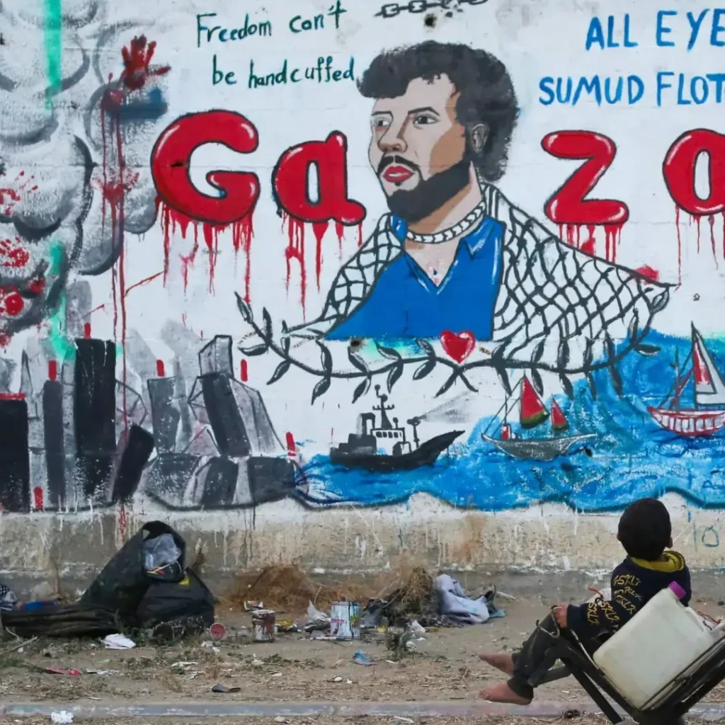 Palestinian children look at a mural depicting Israel's interception of ships participating in the Global Sumud Flotilla, a civilian-led humanitarian aid mission to Gaza by sea