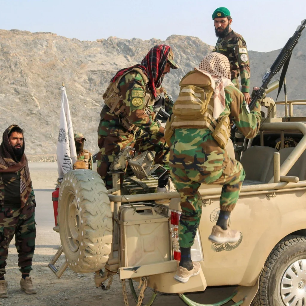 Taliban soldiers carry weapons in a vehicle, near Torkham border in Afghanistan