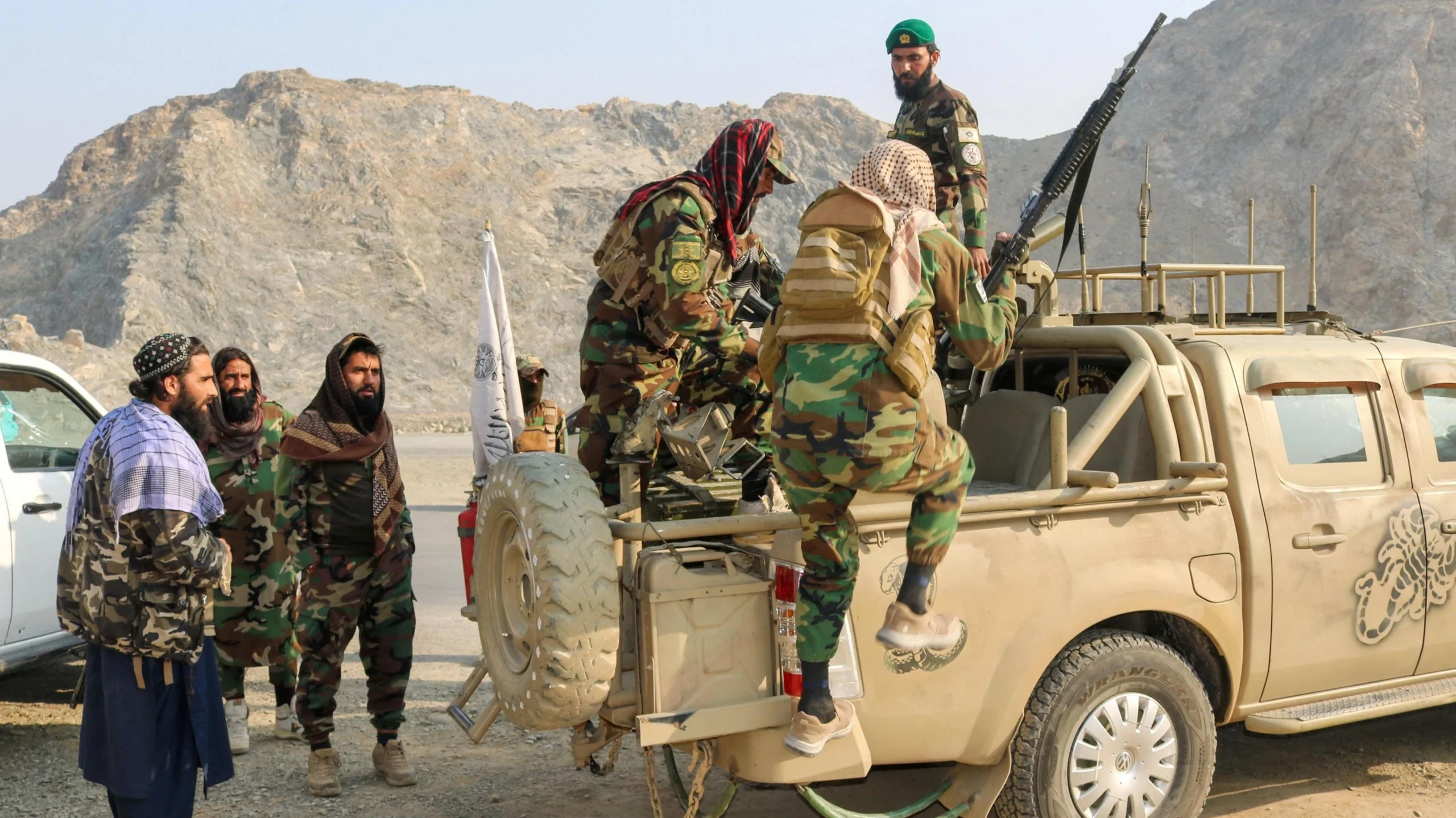 Taliban soldiers carry weapons in a vehicle, near Torkham border in Afghanistan