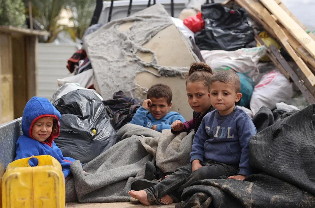 Children sitting in the back of a truck during their displacement from areas witnessing an escalation in hostilities in Rafah, south of the Gaza Strip.