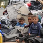 Children sitting in the back of a truck during their displacement from areas witnessing an escalation in hostilities in Rafah, south of the Gaza Strip.