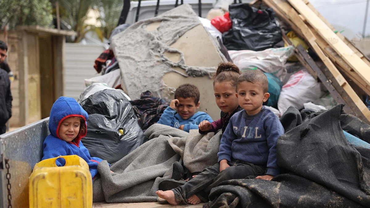 Children sitting in the back of a truck during their displacement from areas witnessing an escalation in hostilities in Rafah, south of the Gaza Strip.