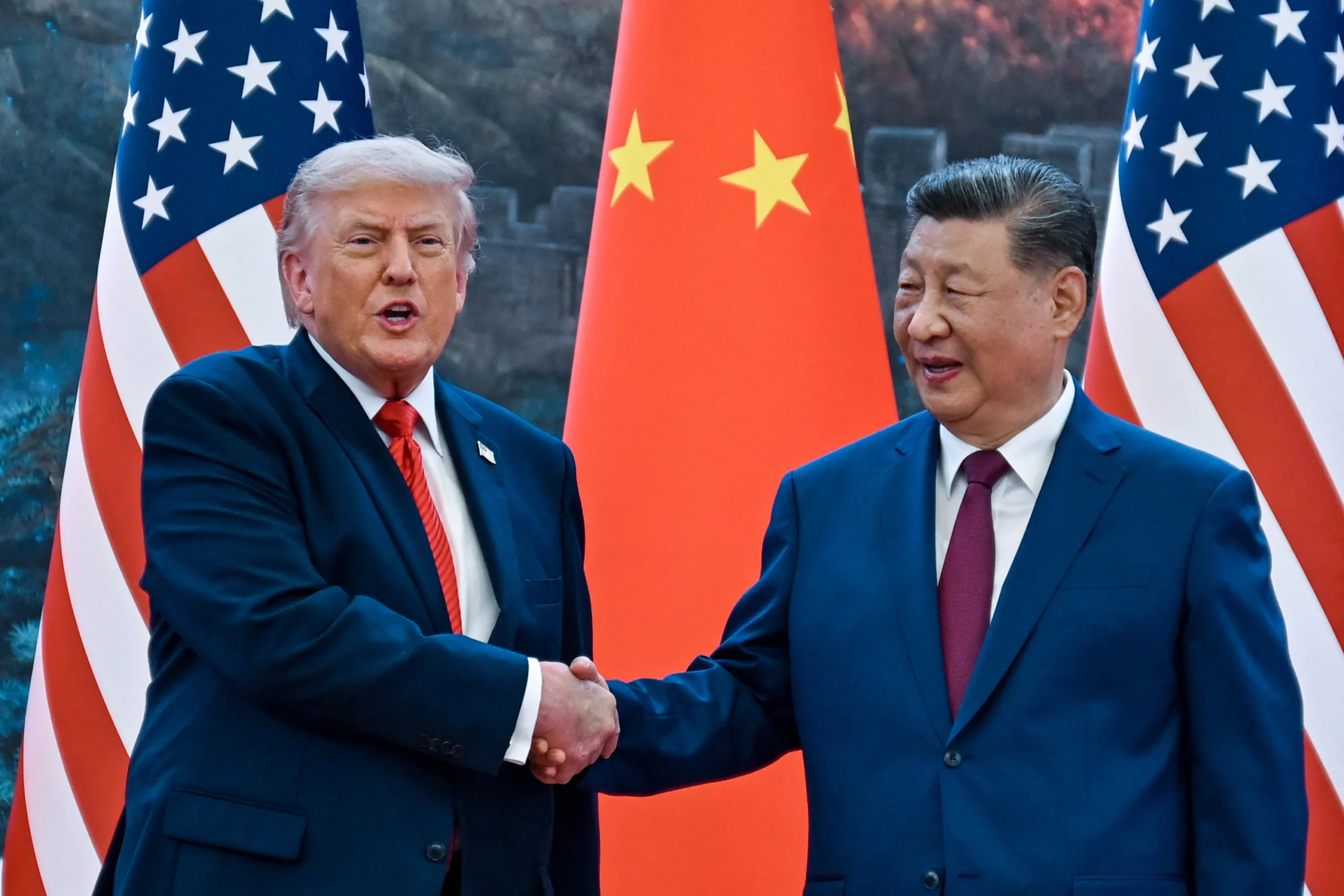 US President Donald Trump shakes hands with Chinese leader Xi Jinping at the Great Hall of the People in Beijing on Thursday, May 14