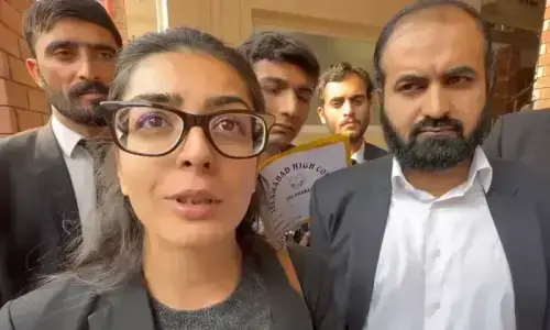 Human rights activist and lawyer Imaan Zainab Mazari-Hazir (left) and her husband, Advocate Hadi Ali Chattha (right), outside a court in Islamabad on November 5, 2025.