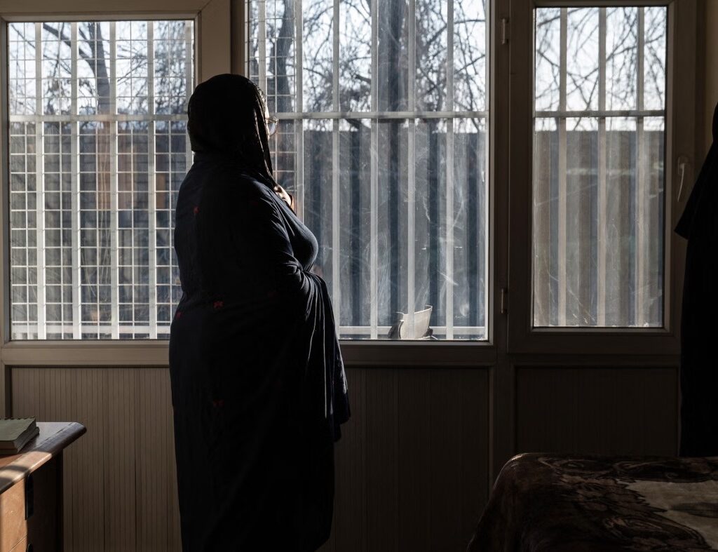An Afghan hospital medic, who studied public relations and journalism before universities were closed to women, stands in a house in Afghanistan, February 17, 2026. © 2026 AFP via Getty Images