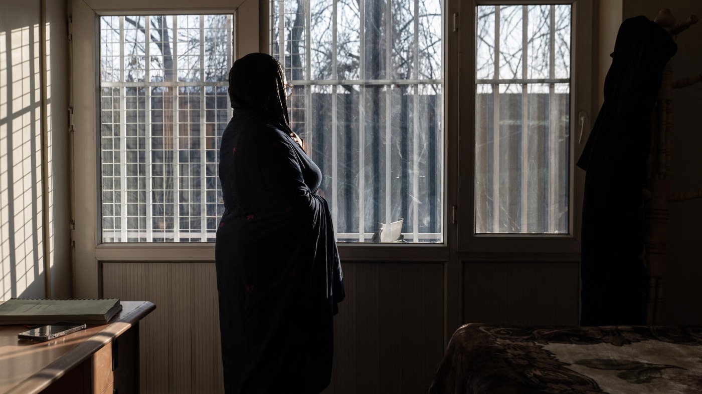 An Afghan hospital medic, who studied public relations and journalism before universities were closed to women, stands in a house in Afghanistan, February 17, 2026. © 2026 AFP via Getty Images