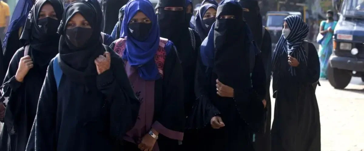 Muslim female students wearing hijabs are denied entry to classrooms in Udupi, reflecting rights violations in India's Karnataka [Image Credits: AP]