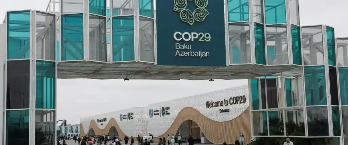 COP29 in Baku faces delays and controversy over climate issues. With key absences and trade disputes, will the summit deliver on urgent climate action? [Image via Reuters]