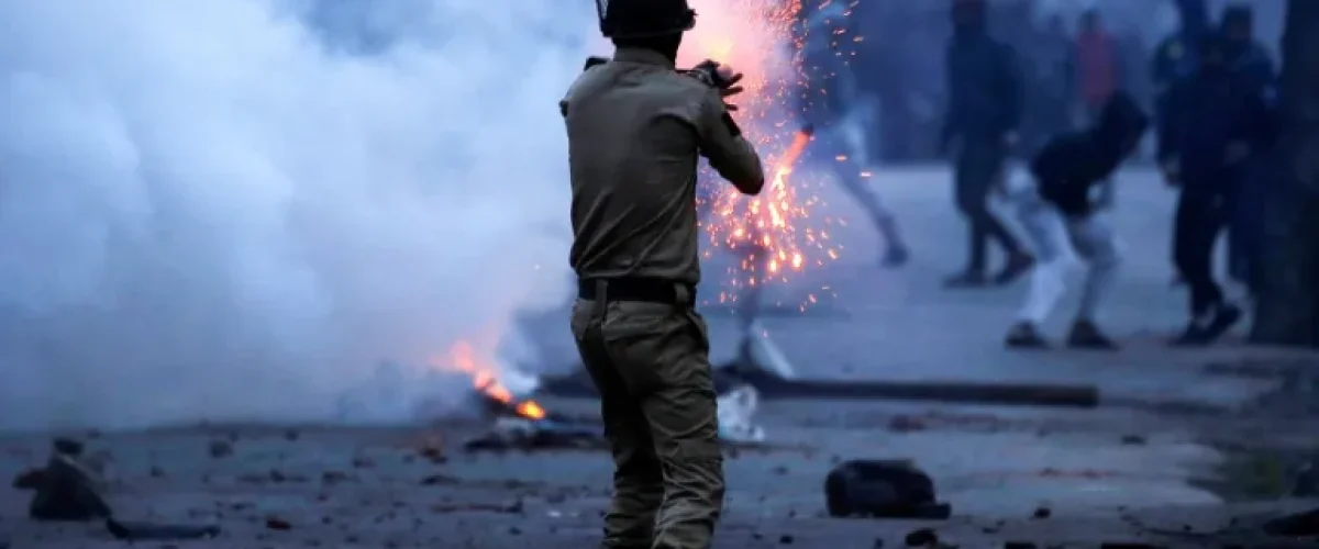An Indian police officer fires a tear gas shell during a protest in Srinagar last year [File: Danish Ismail/Reuters]