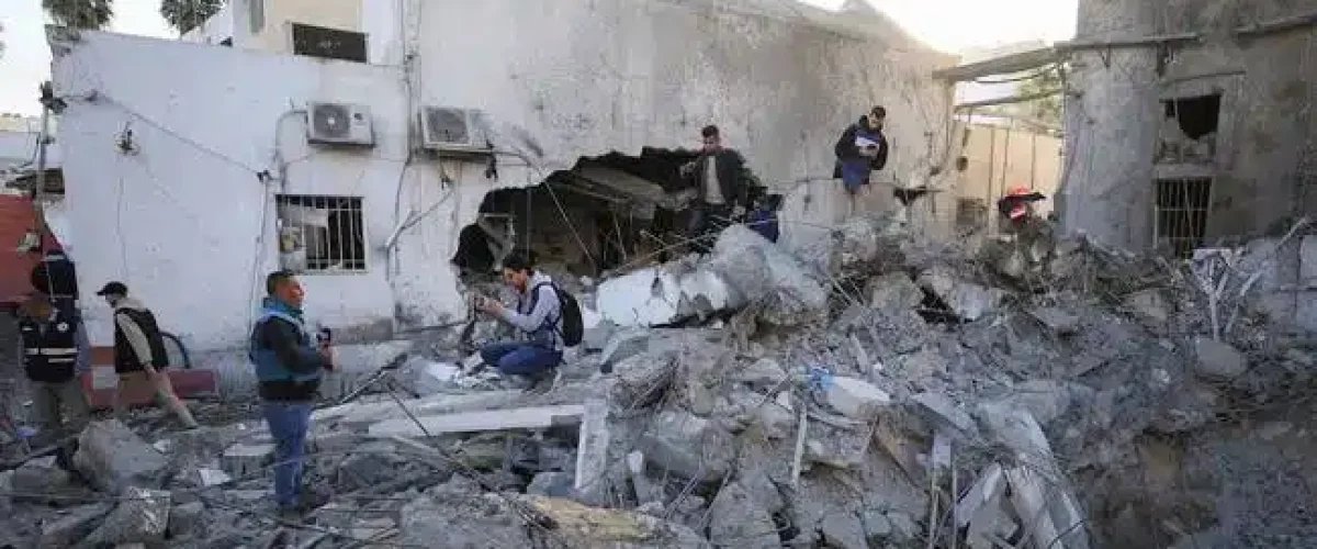Israeli strike hits Gaza’s last active hospital, halting operations amid ceasefire talks; hundreds of patients evacuated. [Image via The Nation]